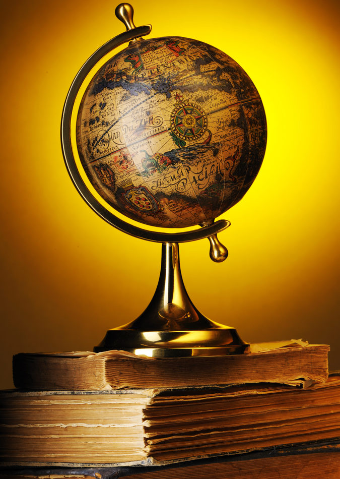 antique-globe-on-old-books-over-yellow