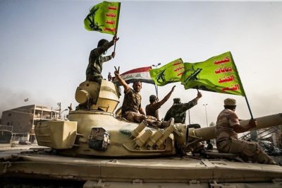 Raising flag of Iraq and Popular Mobilization Forces after defeating DAESH (Source: Mahmoud Hosseini/Tasnim News Agency)